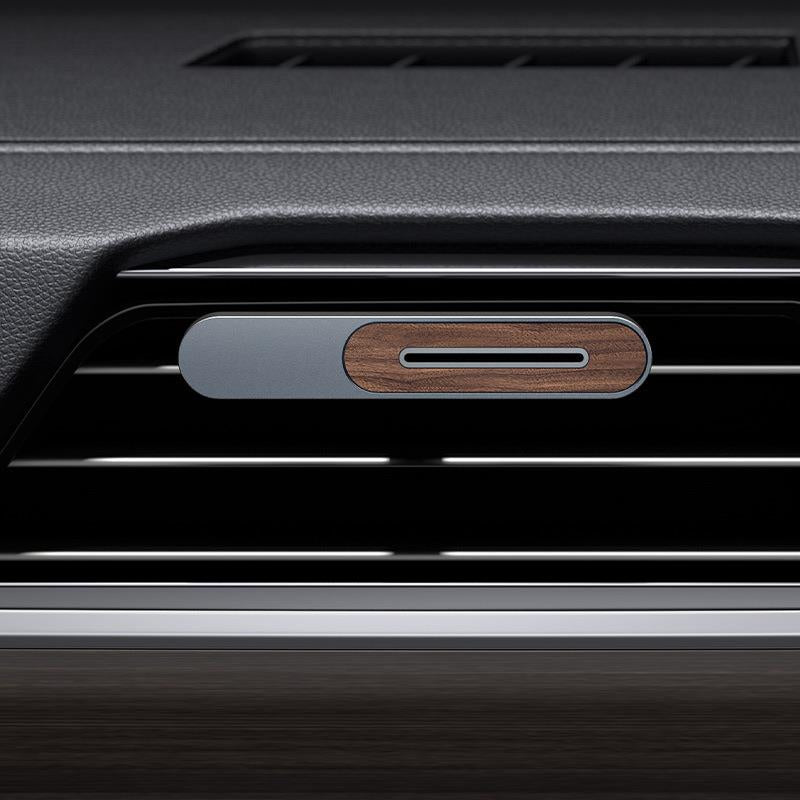 The Dfuse aluminum-and-wood vent clip mounted on a car air vent.